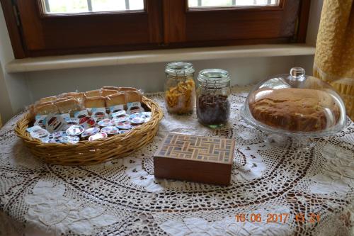 a table with a basket of cookies and a basket of bread at Masseria Fragnale in Fasano