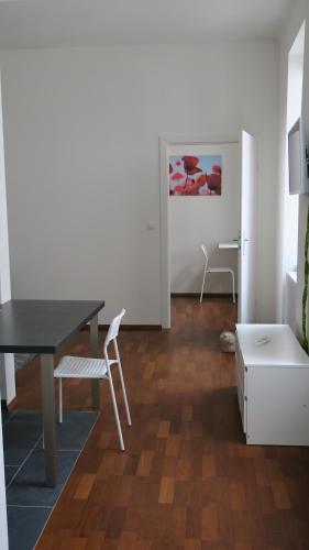 a living room with a table and a chair at 2 Zimmer Wohnung in Vienna