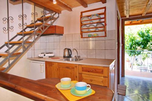 a kitchen with a table with two mugs on it at Alexandra Sofia in Stafylos