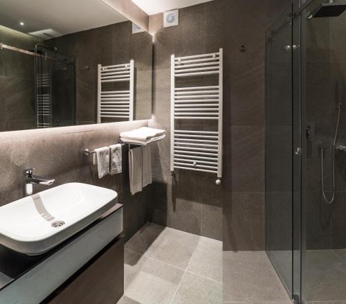 a bathroom with a sink and a shower at Best Western Premier Natalija Residence in Belgrade