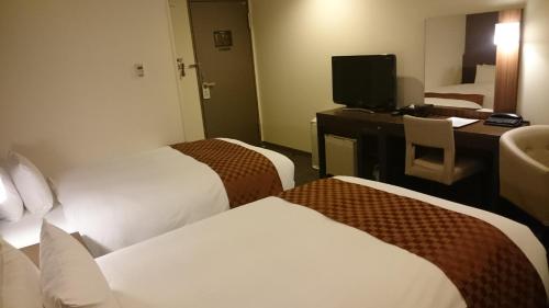 Ένα ή περισσότερα κρεβάτια σε δωμάτιο στο Hotel Ascent Plaza Hamamatsu