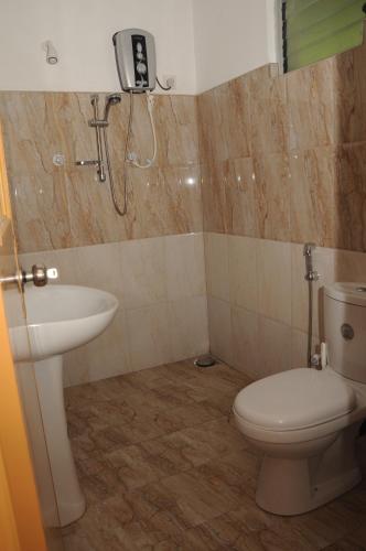 a bathroom with a toilet and a sink at Samanala Garden Holiday Home in Hikkaduwa
