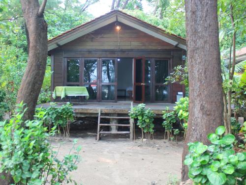 a cabin in the woods with a table and chairs at Seribu Resort Thousand Island in Kepulauan Seribu