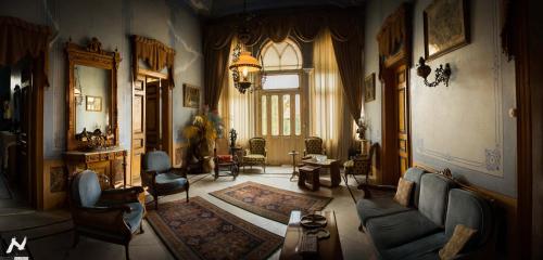 a living room with a couch and chairs at Stone Cellars in Douma