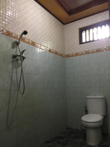 a bathroom with a shower and a toilet at Eka's Homestay in Ubud