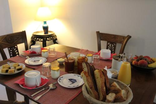a wooden table with a plate of food on it at La Haute Flourie - bed and breakfast -chambres d'hôtes in Saint Malo