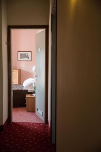 a door to a room with a bed and a bedroom at Hotel Gloria in Salsomaggiore Terme