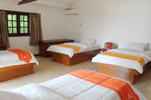 a bedroom with three beds in a room at Seribu Resort Thousand Island in Kepulauan Seribu