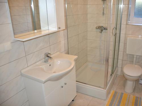 a bathroom with a sink and a shower and a toilet at Apartment Summer Paradise in Novalja
