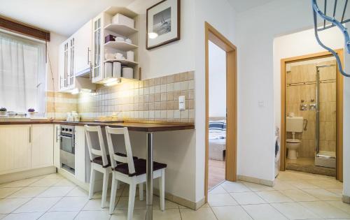 a kitchen with a table and chairs in a room at Lovely Corvin Apartment in Budapest