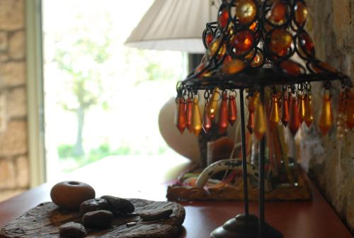 a glass lamp sitting on a table next to a window at Pili Country House in Pili
