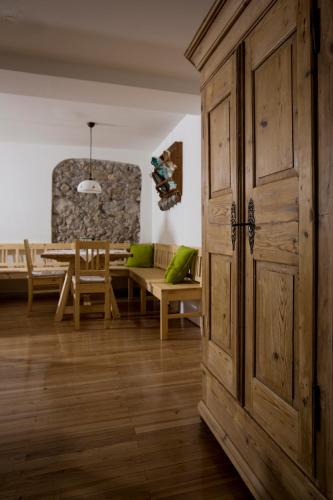a room with a wooden cabinet and a dining room at Bierhotel Ranklleiten Almtal in Pettenbach