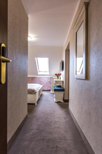 a corridor of a room with a bed and a window at Boutique Hotel Annuska in Balatonfüred