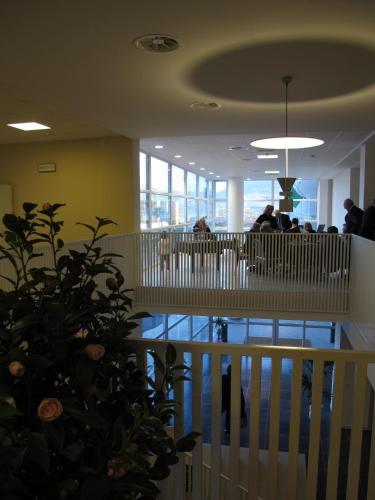 a lobby with a plant in the middle of a building at Santa Loja Hotel Residence in Tito
