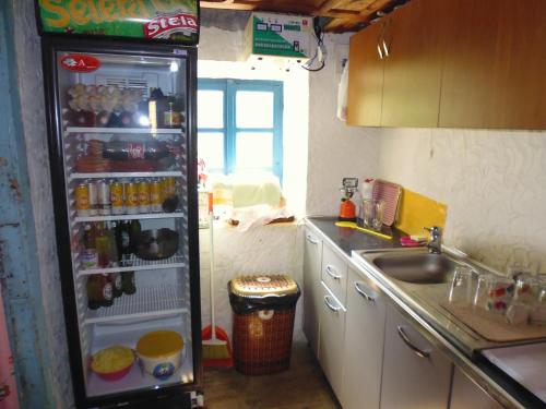 a kitchen with a refrigerator full of food and drinks at Kulla e Sadri Lukes in Theth