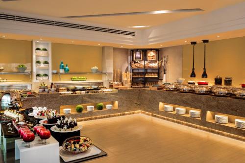 a restaurant with a pool in the middle of a room at Jumeira Rotana – Dubai in Dubai