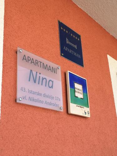 a sign on the side of a building at Apartments Nina in Umag