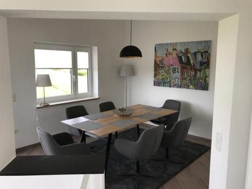 a dining room with a wooden table and chairs at Ferienhaus Eckeweg 1 in Waldeck