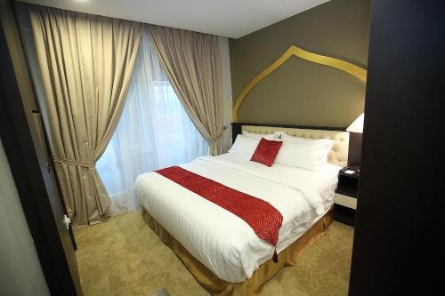 Un dormitorio con una cama grande y una ventana en Al Khatiri Hotel en Kubang Kerian