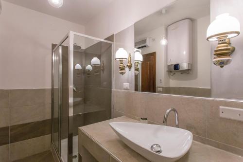 a bathroom with a sink and a mirror at Navona apartment in Rome