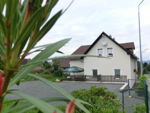 a white house with a black roof at Pension Skalka in Liberec