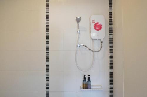 a shower with a shower head in a bathroom at TF Apartment in Chiang Mai