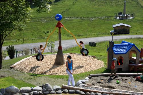 a group of children playing on a playground at Berghaus Koglmoos in Auffach