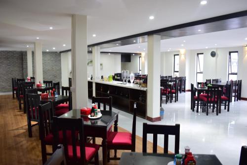 a restaurant with tables and chairs and a bar at Phuong Nam Hotel in Sa Pa