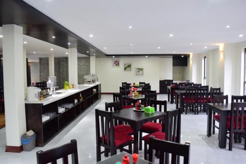 a restaurant with black tables and red chairs at Phuong Nam Hotel in Sa Pa