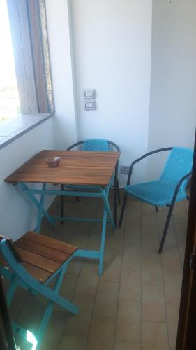 a table and chairs in a room with a window at B&B Villa Patrizia in Ercolano