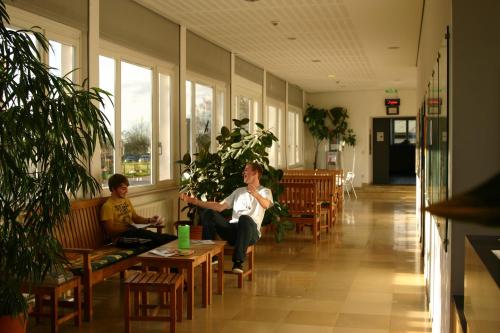 a woman and a child sitting in a waiting room at Jugendherberge Otto-Moericke-Turm in Konstanz