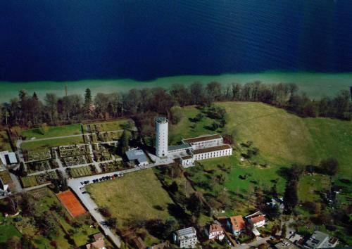 an aerial view of a building on a hill next to the water at Jugendherberge Otto-Moericke-Turm in Konstanz