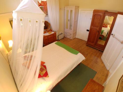 a bedroom with a bed with a canopy at Sons of the King Guest House in De Rust