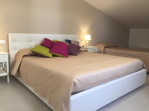 a bedroom with a large bed with colorful pillows at Linda's B&B in Ragusa