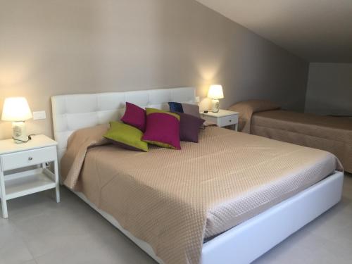a bedroom with a large bed with two night stands at Linda's B&B in Ragusa