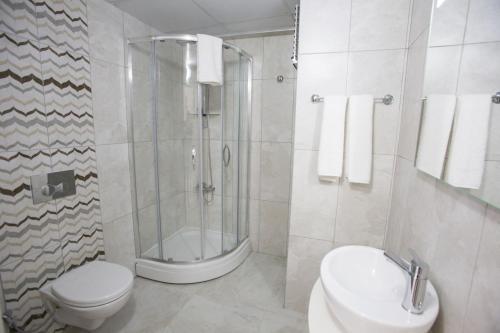 a bathroom with a shower and a toilet and a sink at Pruva Prestige Hotel in Ordu