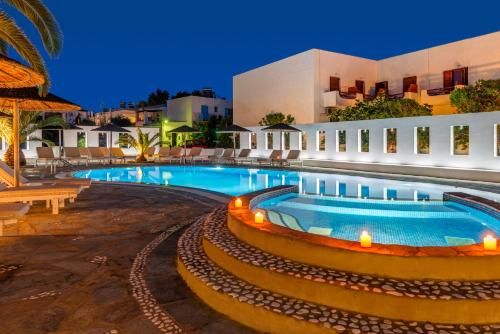 a resort with a swimming pool at night at Hotel Benois in Galissas