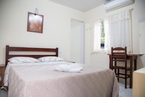 Ένα ή περισσότερα κρεβάτια σε δωμάτιο στο Hotel Turiassú