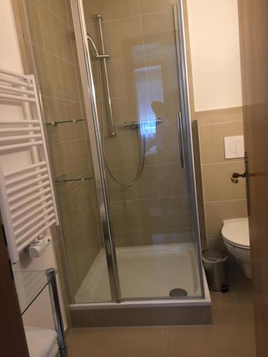 a shower with a glass door in a bathroom at Pension Marion in Binz