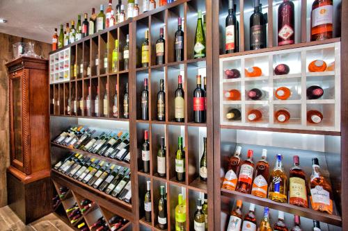 a shelf filled with lots of bottles of wine at Wellness & Spa Hotel ACD in Herceg-Novi