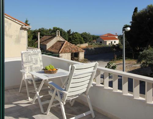 a table and two chairs on a balcony at Apartments Močići in Močići
