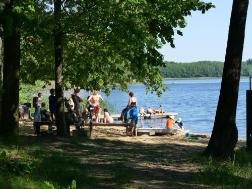 a group of people on the shore of a lake at Eurocamp Spreewaldtor in Groß Leuthen