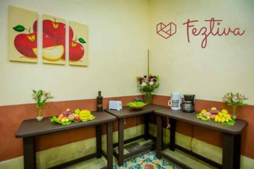 two tables in a room with fruit on them at Hostal La Ermita in Mérida