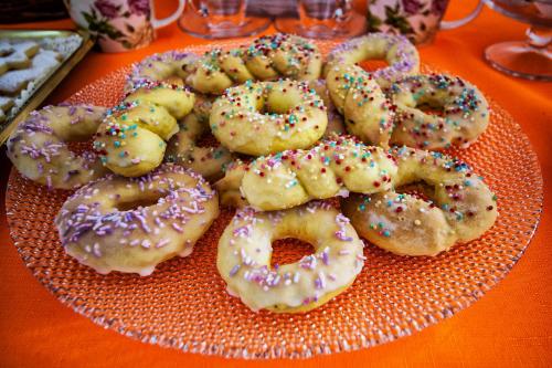 a plate of donuts with sprinkles on a table at Isola Antica in SantʼAntìoco