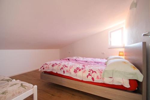 a bedroom with a bed and a window at Apartments Jadranka Sain in Novigrad Istria