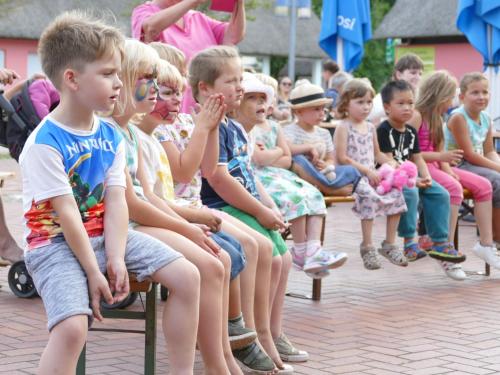a group of young children sitting on benches at Eurocamp Spreewaldtor in Groß Leuthen