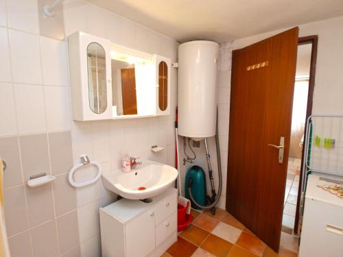a small bathroom with a sink and a mirror at Apartments Milica 1391 in Banjole