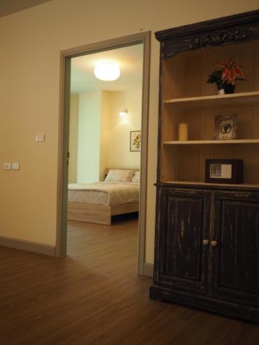a room with a bedroom with a bed and a mirror at Baan Rub Lom by Jane in Pak Chong