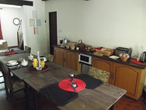 a kitchen with a wooden table with red plates on it at 43 Rue des Quarts in Ménesplet
