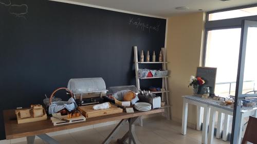 a table withcellaneous items on it in a room at Ostria Hotel Kakovatos Beach in Zakharo